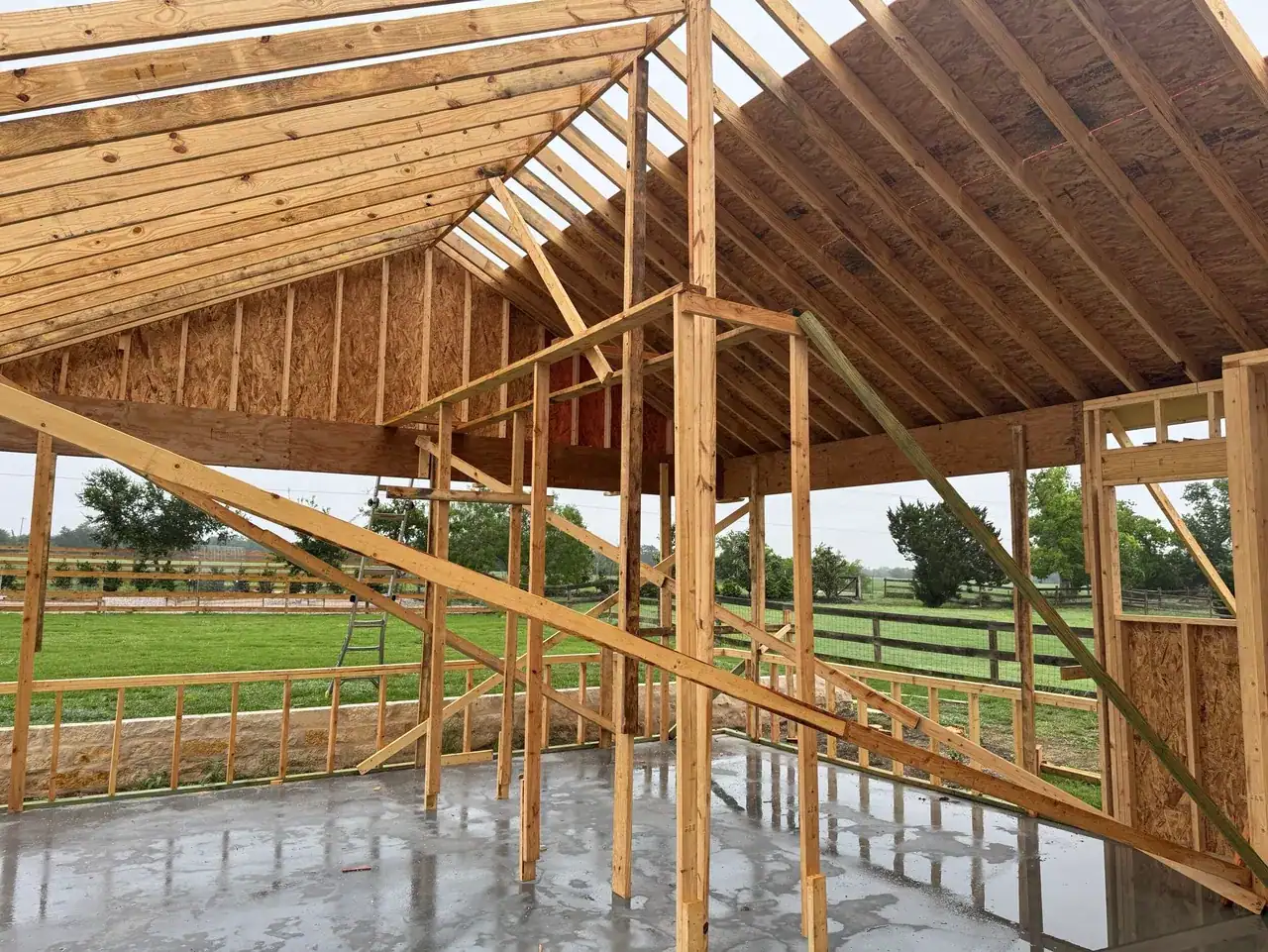 Pool cabana roof and wall framing with views toward the surrounding property