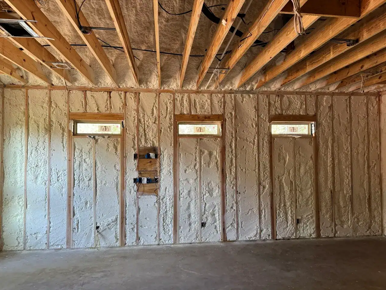 Insulation between exposed wall studs and ceiling framing in a casita