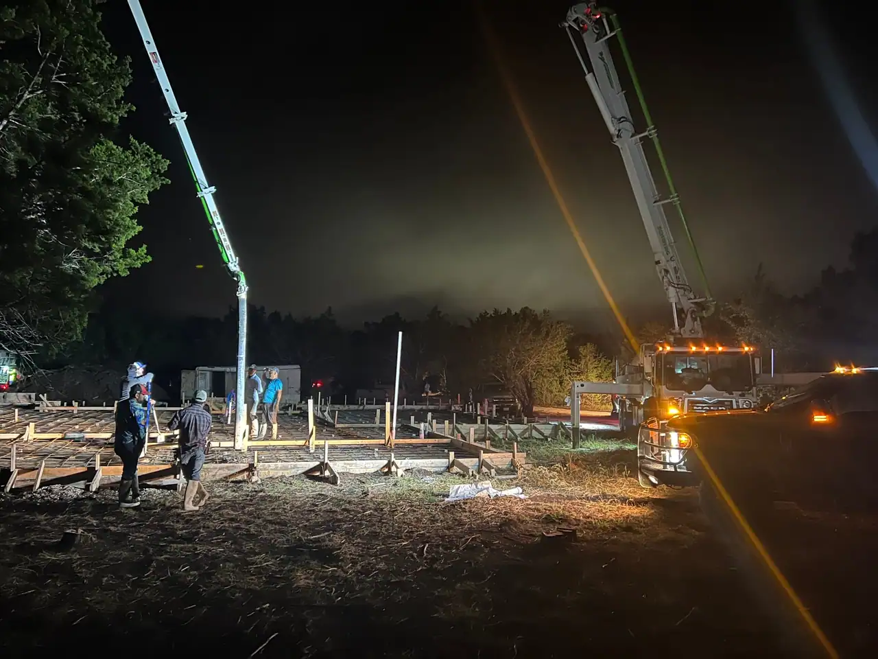 Crew and a concrete pump truck at the pre-dawn slab pour for the new Dripping Springs home