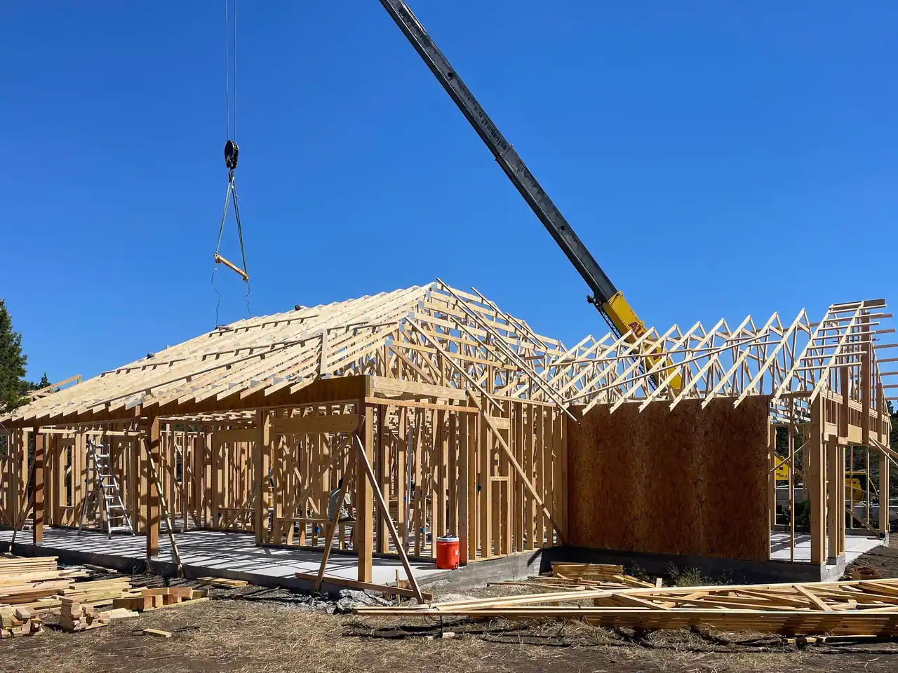 Crane setting roof trusses on the new Dripping Springs home