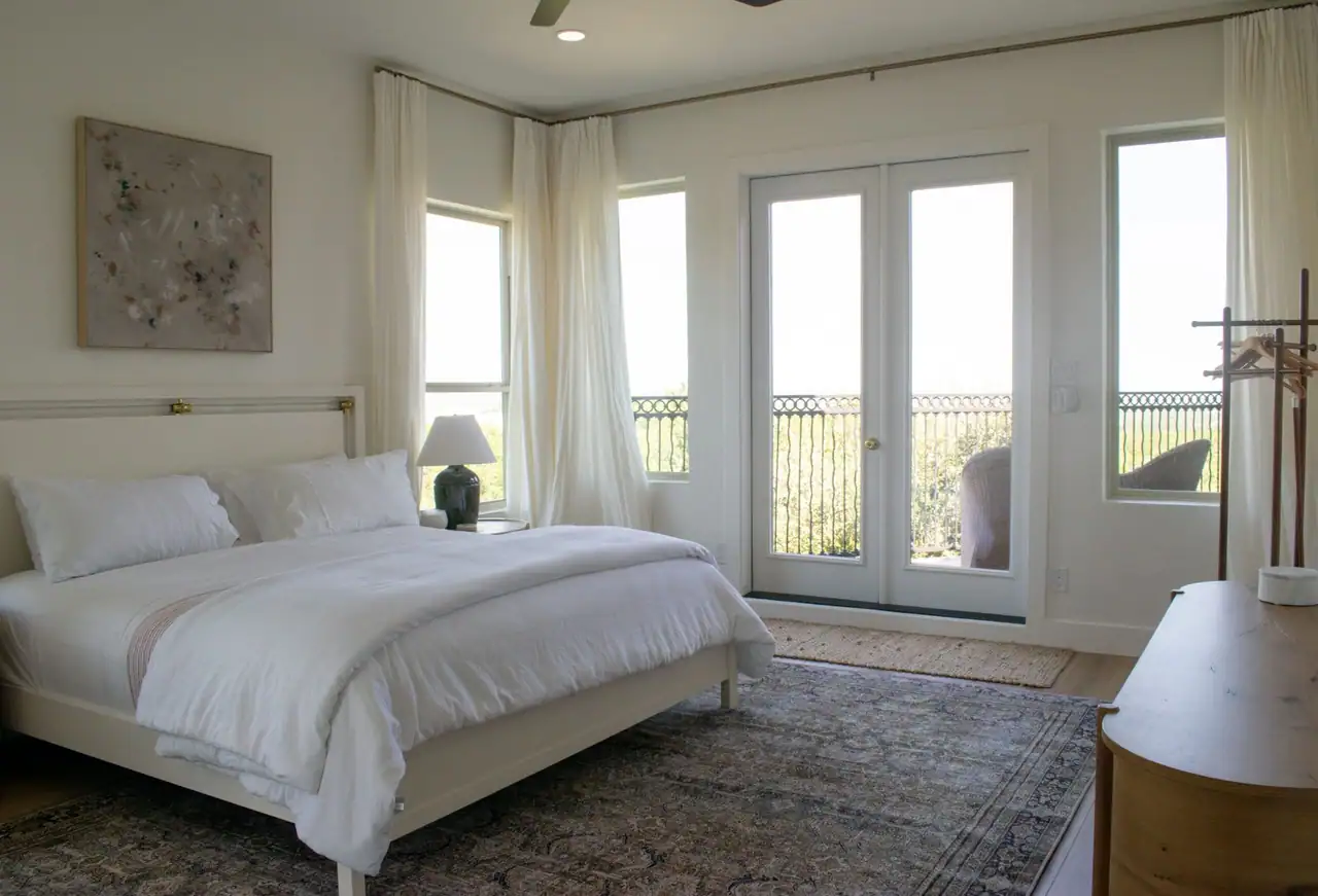 Primary bedroom with French doors in a custom home