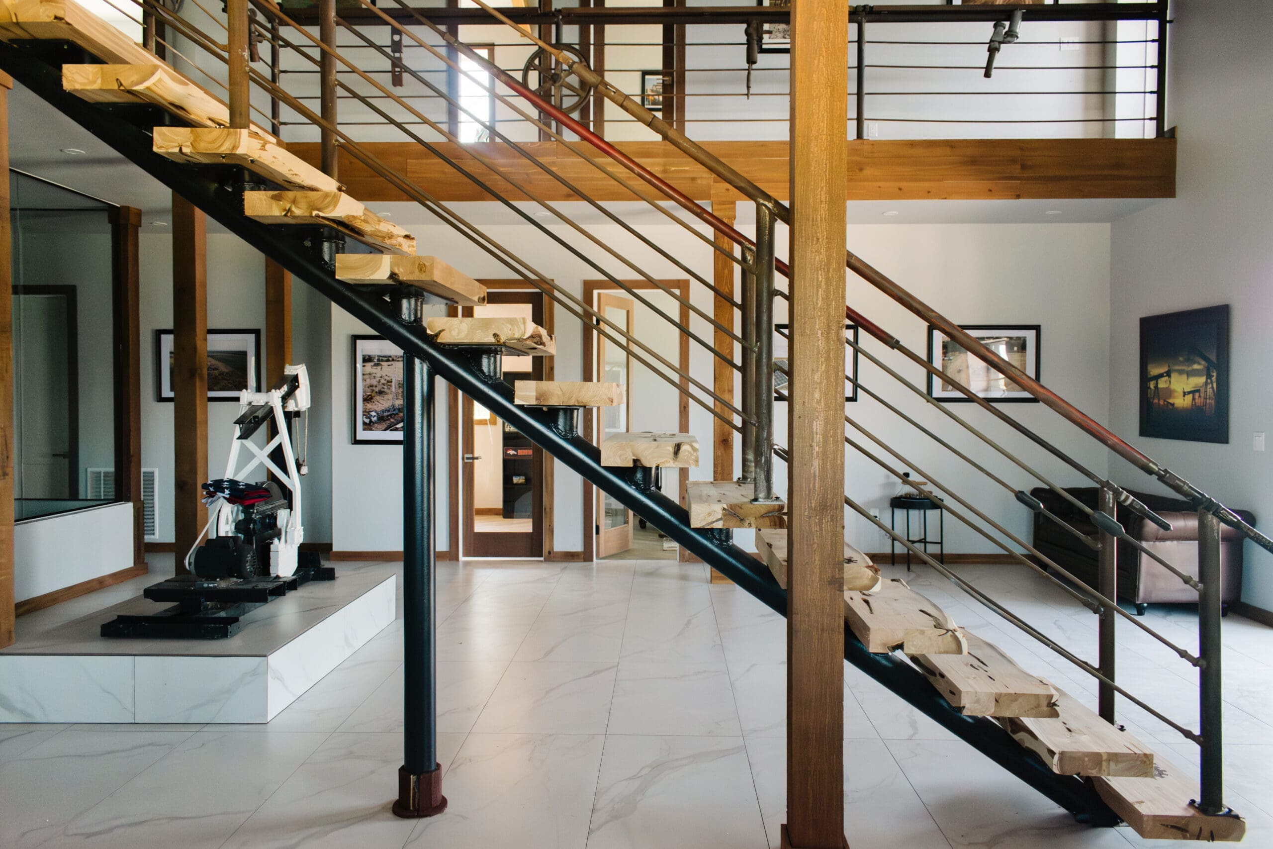 Steel staircase and gym area in a barndominium interior
