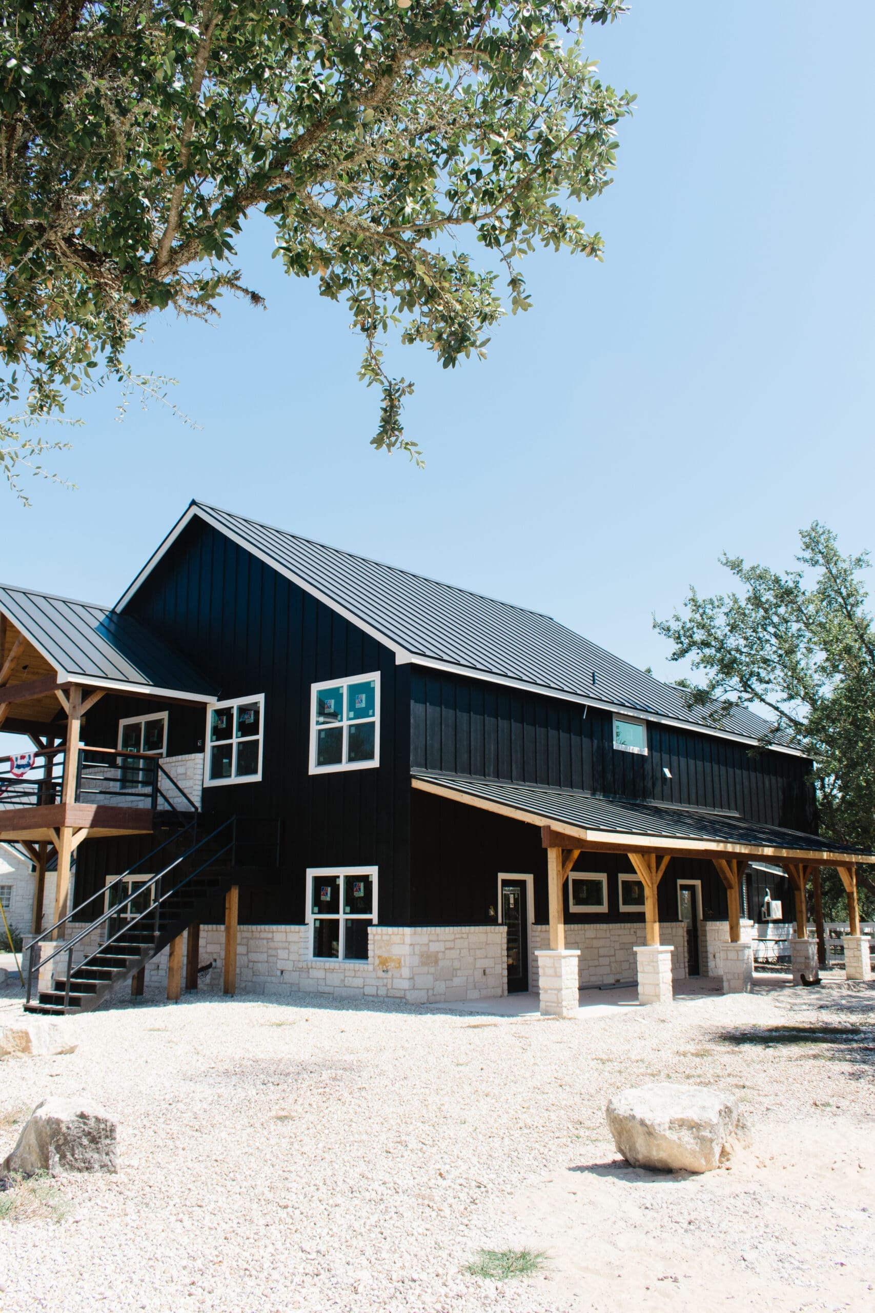 Navy metal barn with white-trimmed windows