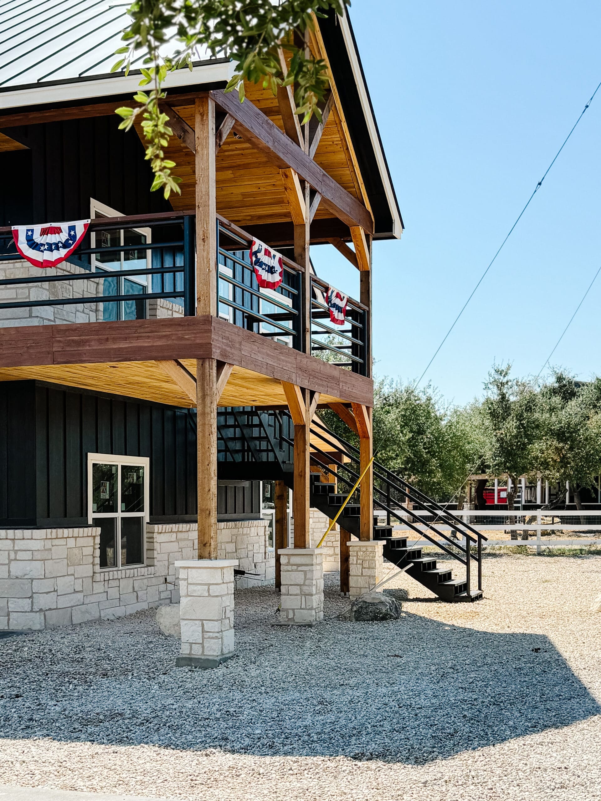 Black party barn with cedar pergola entrance