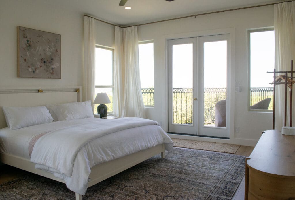 Primary bedroom with French doors in a custom home