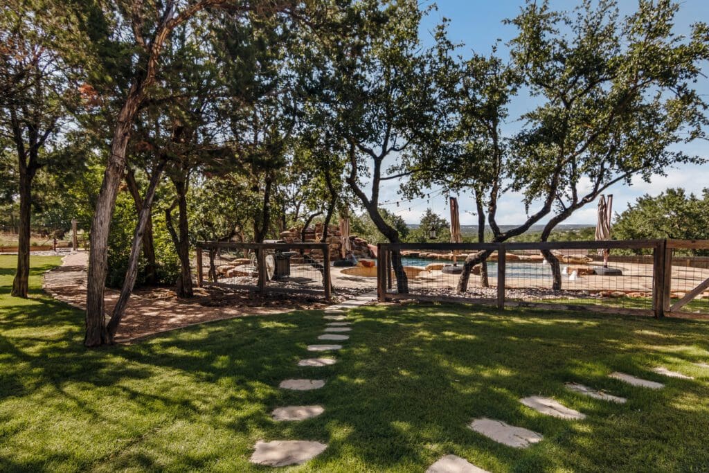 Oak-shaded lawn on Hill Country acreage at a Ridge Rock Builders property