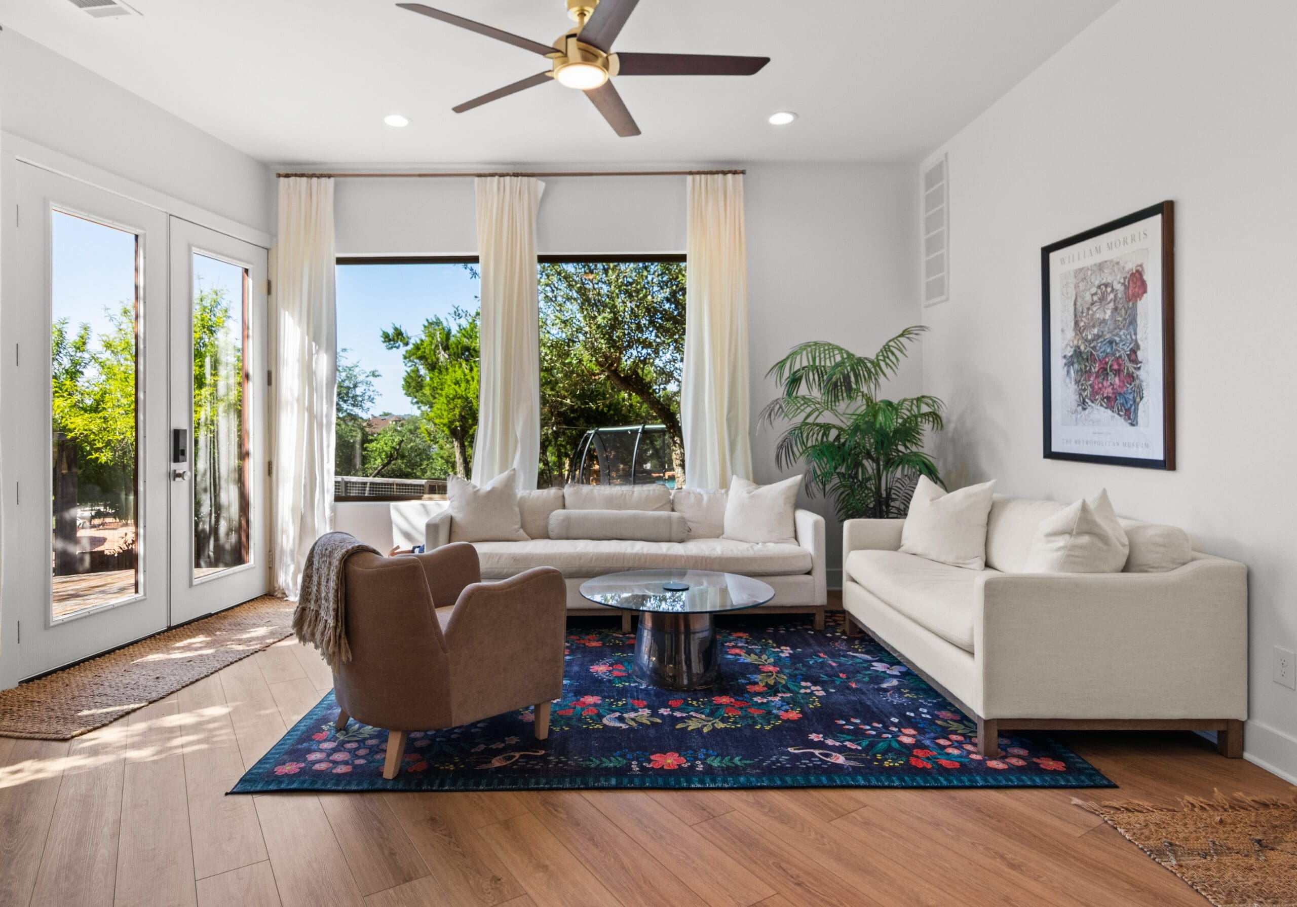 Bright casita living room with large windows and Hill Country views in a guest house by Ridge Rock Builders