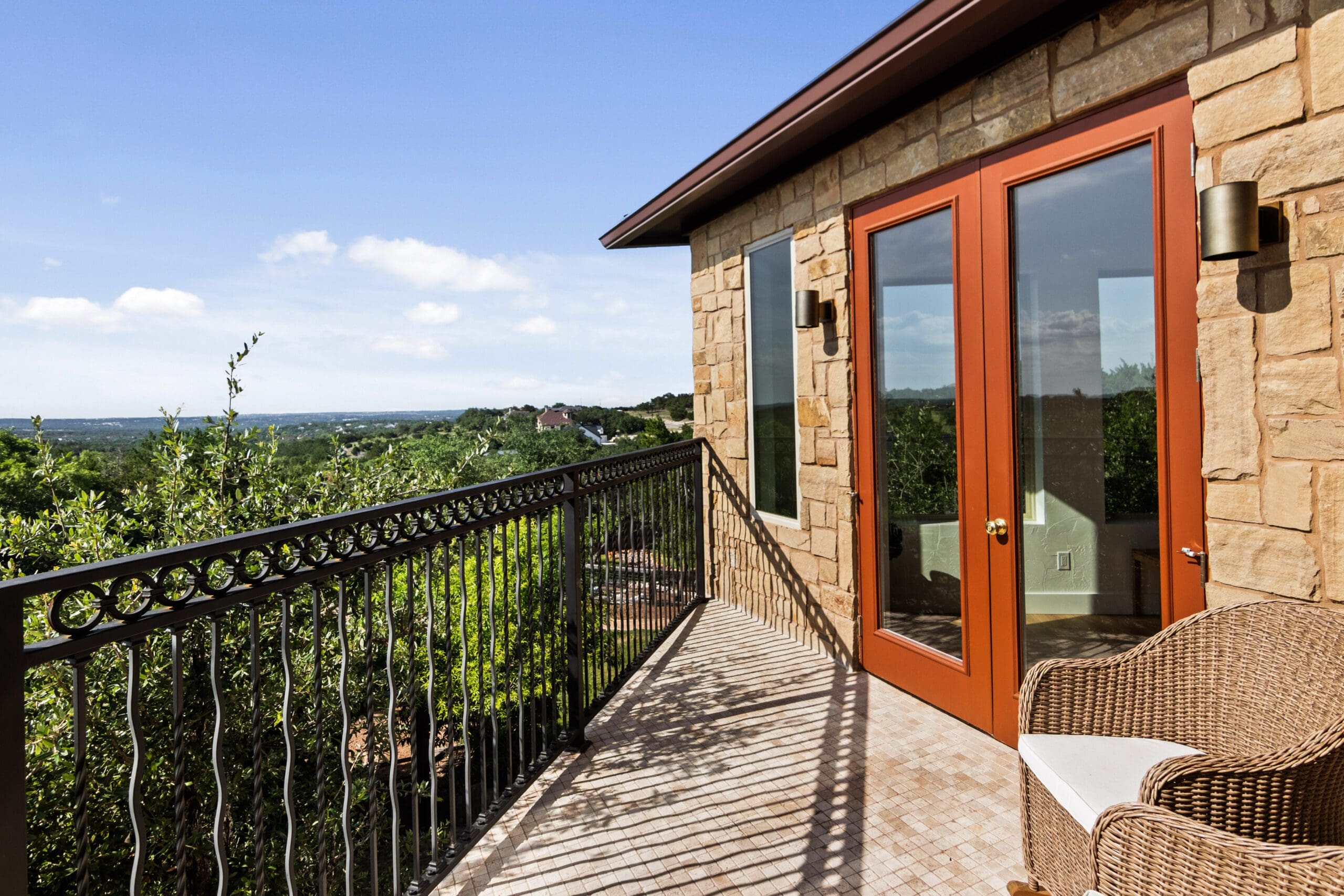 Covered balcony and Hill Country view at a Ridge Rock custom home