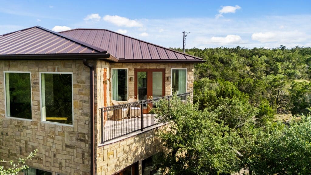 Stone Canyonwood casita with metal roof and covered balcony