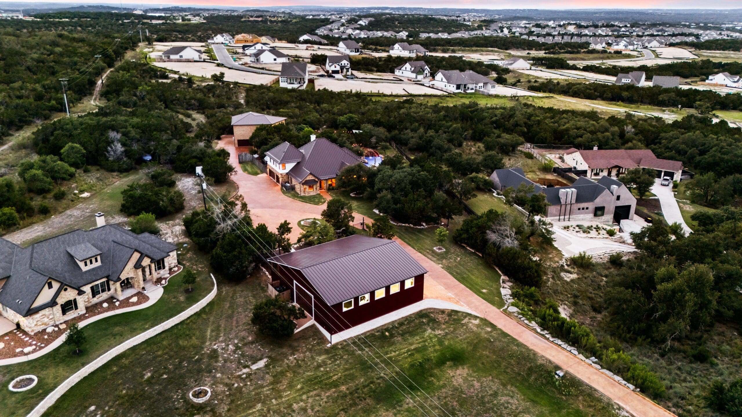 Ridge Rock custom home, barn, drives, and Hill Country acreage viewed from above