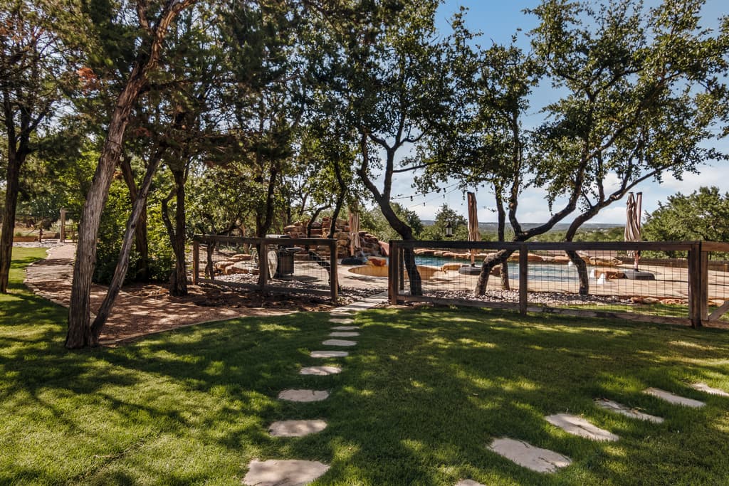 Oak-shaded lawn on Hill Country acreage at a Ridge Rock Builders property